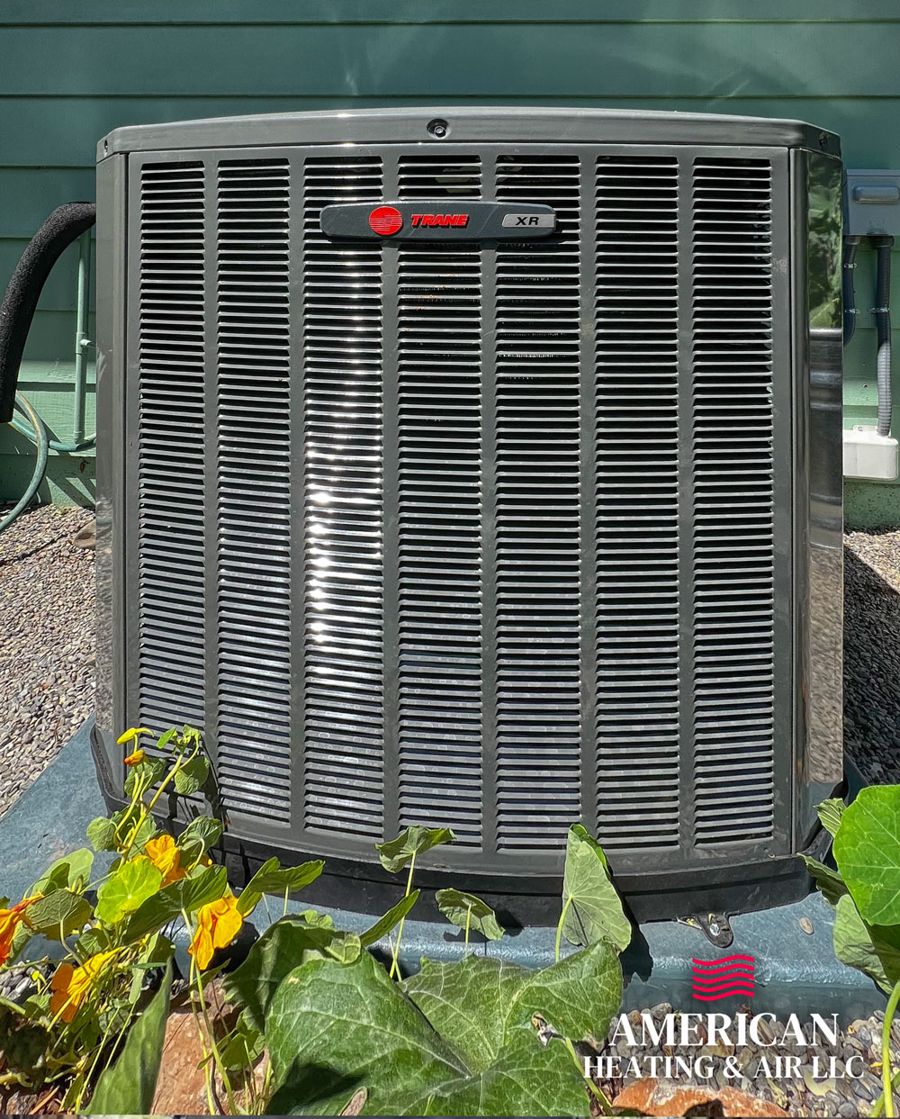 New outdoor AC condenser installed beside a home