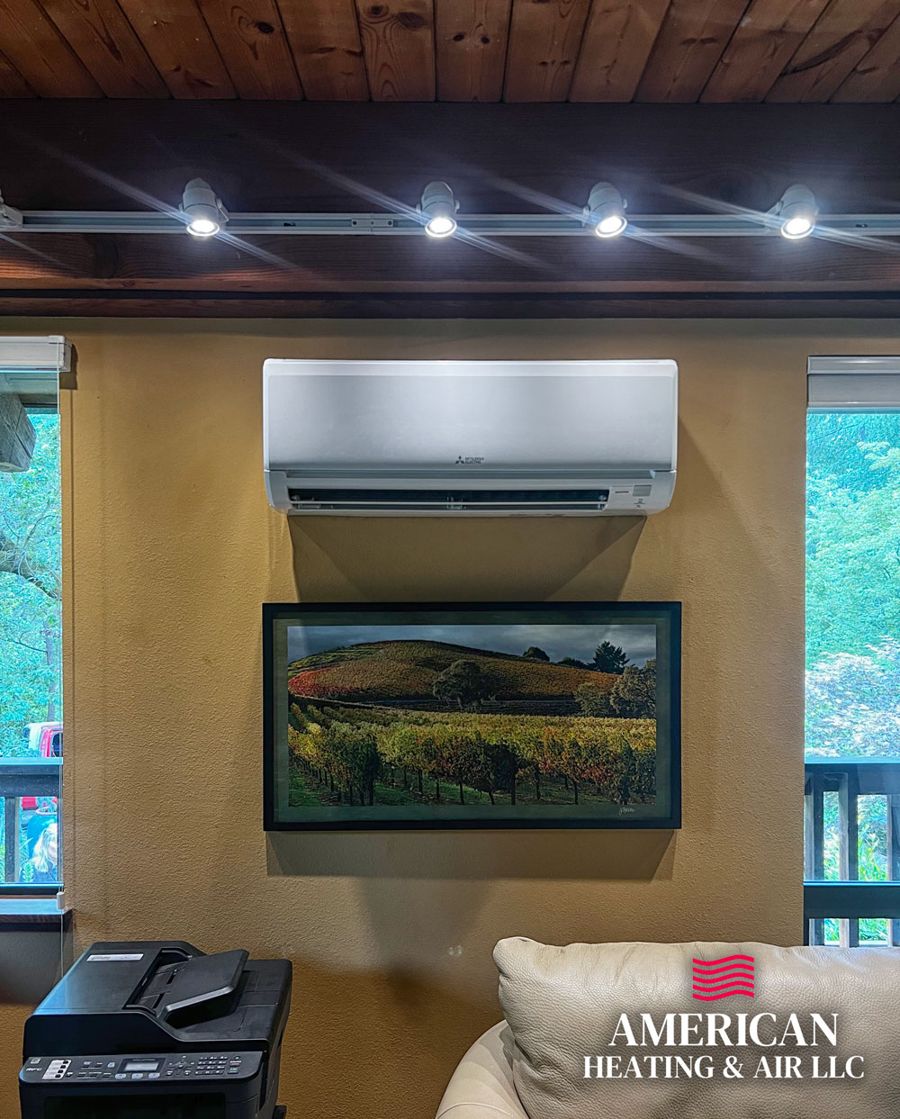 Ductless mini split mounted above artwork in a living room